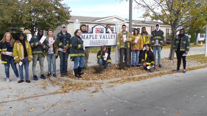 Fire-Rescue-EMR Students standing around Maple Valley Providence Sign